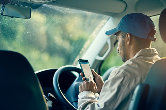 Delivery driver checking route on smartphone