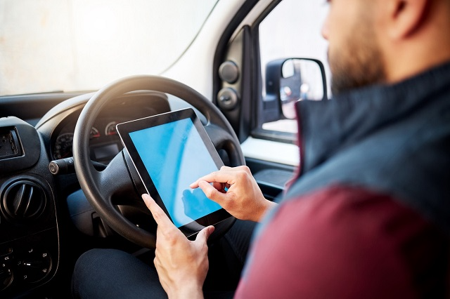 Driver reviewing his delivery route on a tablet