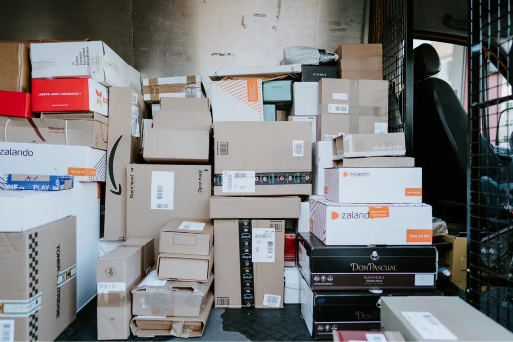 piles of shipping packages in back of van