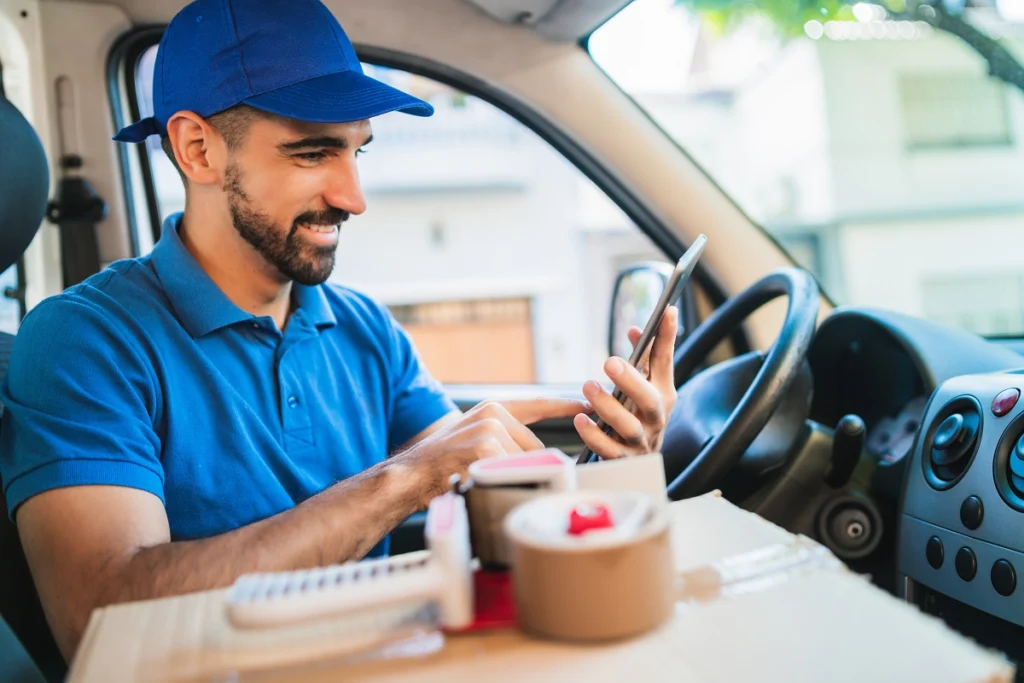 Delivery driver checking smartphone