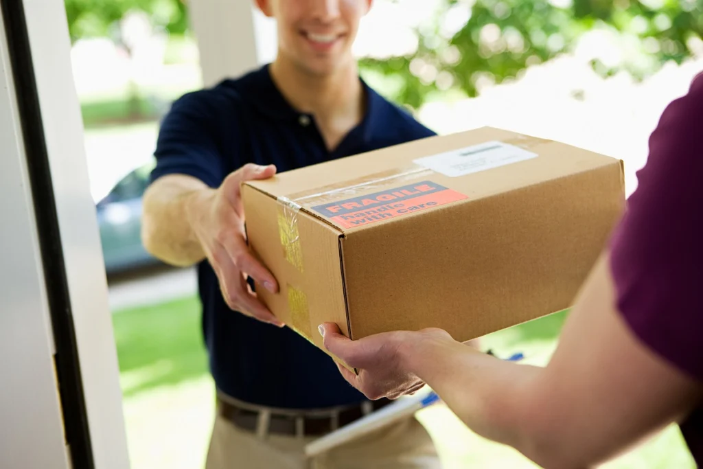 Delivery driver handing a package to a customer