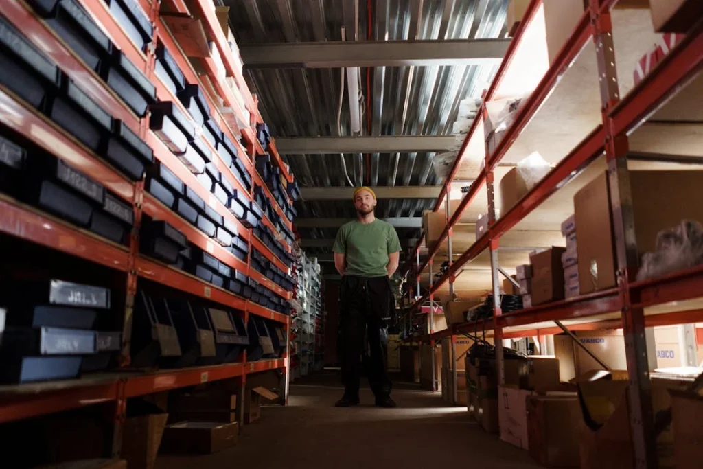 Worker standing in warehouse aisle