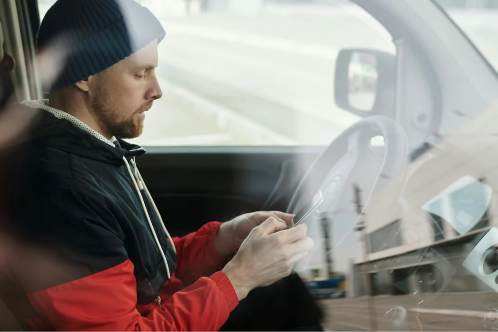 Delivery driver looking at a smartphone