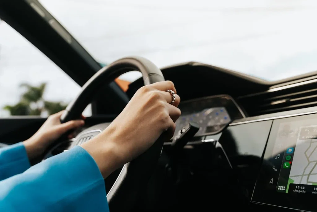 Drivers hands on a steering wheel