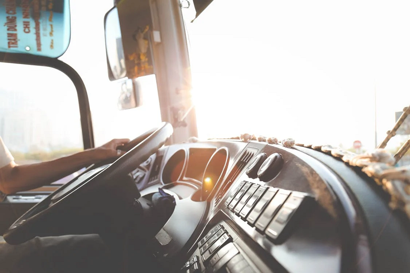 Interior of a fleet vehicle with a hand on the steering wheel