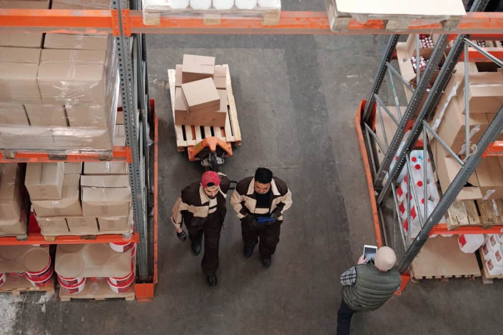 Warehouse workers moving goods at a retail distribution center