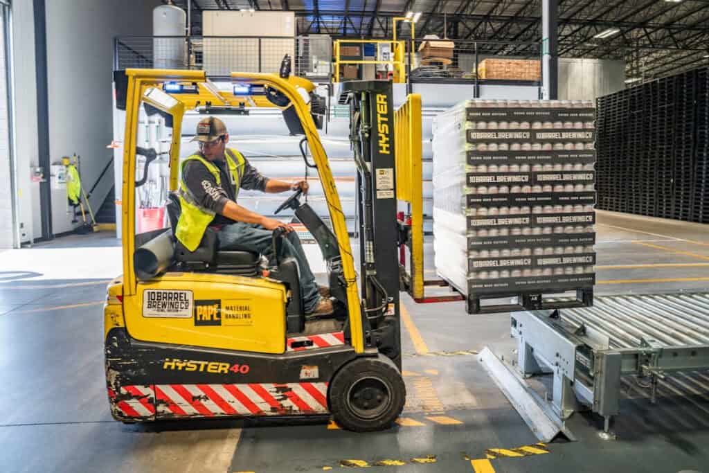 Worker driving a forklift in a retail distribution center